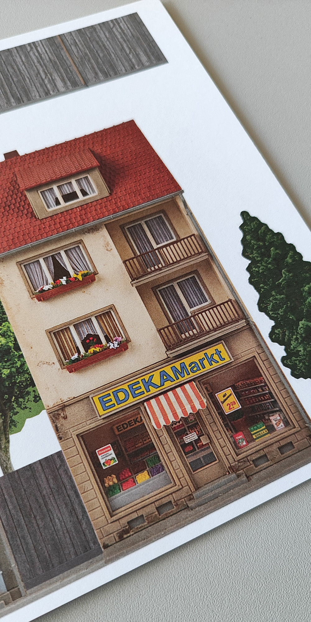 Model railway background two-story buildings bike shop and Edeka H0 with trees and plank fence 1:87